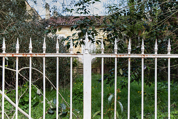 Closed gate of an abandoned house in a village