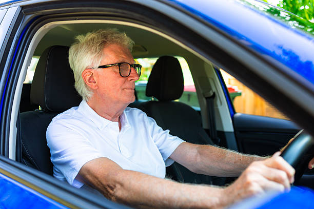 istock Senior man wearing eyeglasses while driving car 2229891252