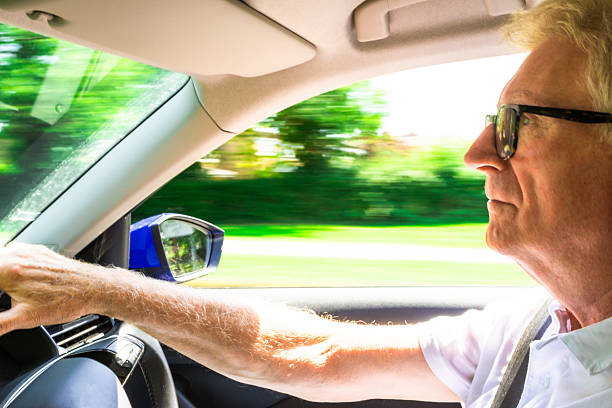 istock Senior man wearing eyeglasses while driving car 2229891303
