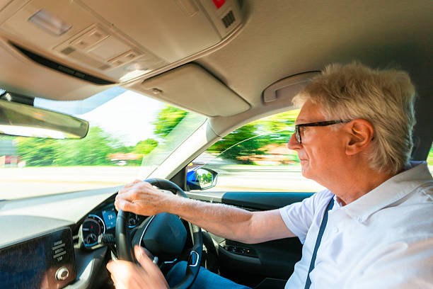istock Senior man wearing eyeglasses while driving car 2229891329