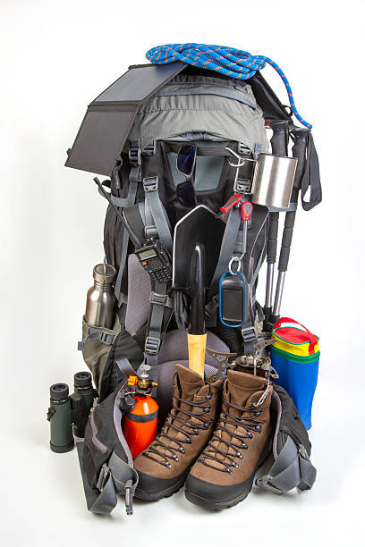 istock Essential hiking gear arranged with backpack, boots, and tools for outdoor adventures 2229893553