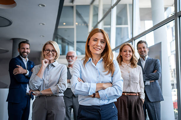 istock Confident business team smiling at the camera in modern office 2229894125
