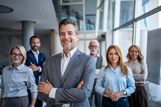 istock Smiling businessman leading his team in modern office 2229894424