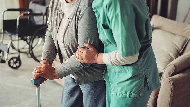 istock The nurse is helping the old patient with a cane 2229894662