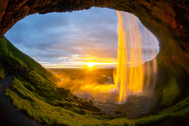 istock Beautiful sunset view from inside Seljalandsfoss waterfall in Iceland 2229895603