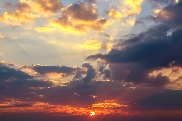istock Stunning sunset with vibrant clouds and warm colors over a tranquil horizon 2229895618