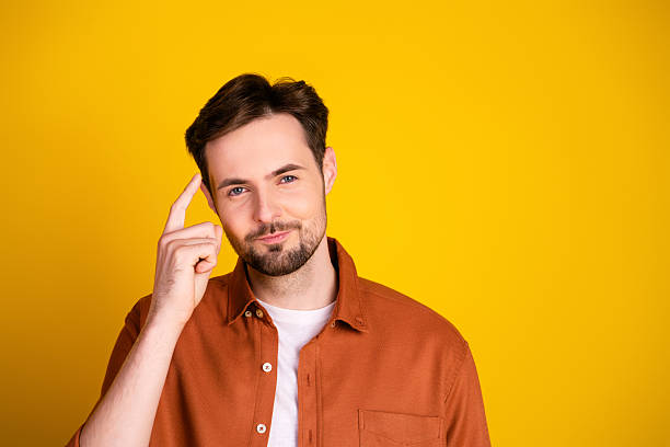 istock Young man performing thoughtful gesture on vibrant background conveying determination and individuality 2229896297