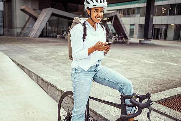 istock Young Multiracial Female Commuting on Bicycle Using Smartphone 2229897020