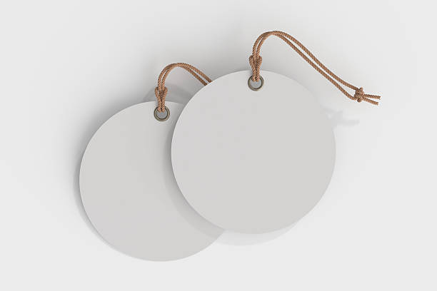 istock 3D blank circle cardboard paper hang tags, price tags or cloth labels mockup with string isolated on background. Tag realistic template for presents branding, shopping label, wedding tag, gift tag 2229899643