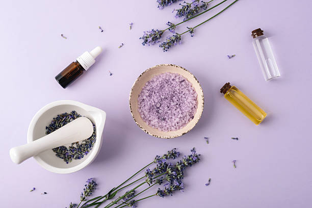 istock Lavender spa composition with sea salt, essential oils and mortar on pastel background. Top view, flat lay 2229900866