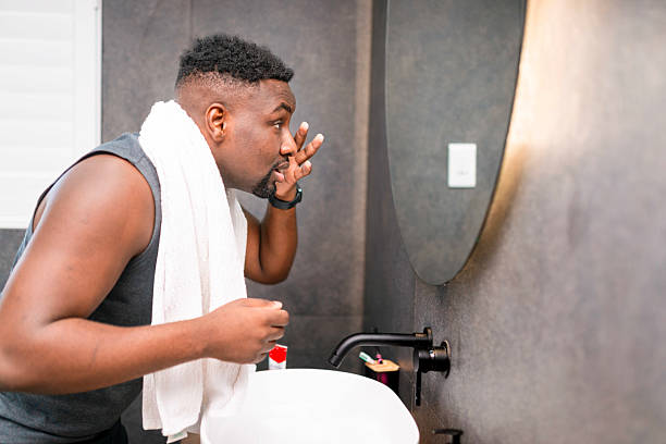 istock Man Grooming in Bathroom Mirror with Towel and Compact Sink 2229901093