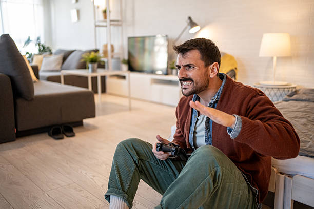 istock Frustrated gamer yelling at tv while playing video games 2229902206