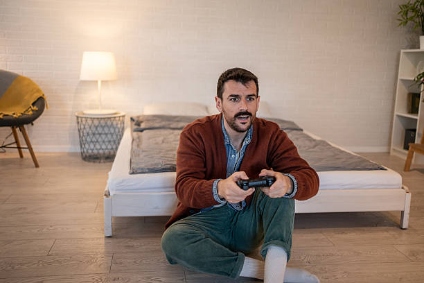 istock Young man playing videogames at home in his bedroom 2229902314