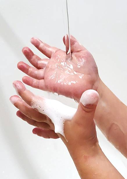 istock Hand Hygiene: Stream of Water and Foam on Child's Palms 2229902484