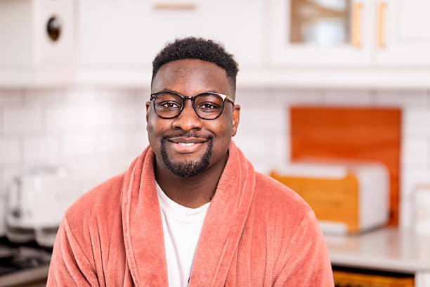 istock Smiling Man Enjoying Morning in Cozy Robe in Bright Modern Kitchen 2229903349