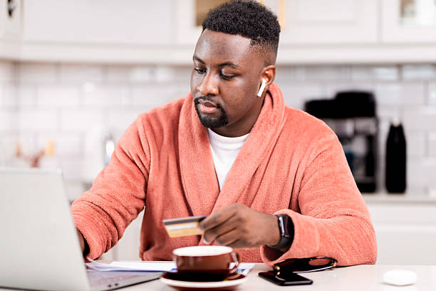 istock Man in Morning Routine Making Online Payments From Home Office 2229903400