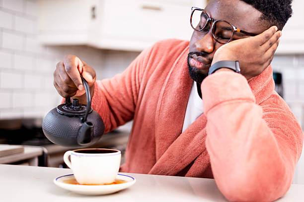 istock Tired Man Pouring Tea in a Kitchen During Morning Routine 2229903414