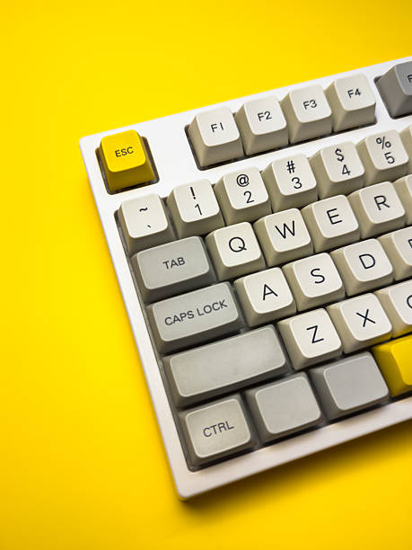 istock White mechanical keyboard with bright Esc key on bright yellow background, minimalism, keyboard buttons. A keyboard with a yellow key on the bottom left 2229907861