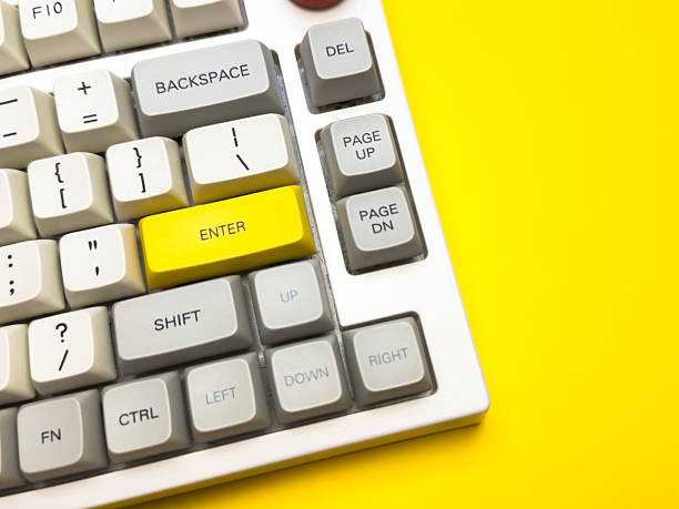 istock White mechanical keyboard with bright Enter key on bright yellow background, minimalism, keyboard buttons. A keyboard with a yellow key on the bottom left 2229907975