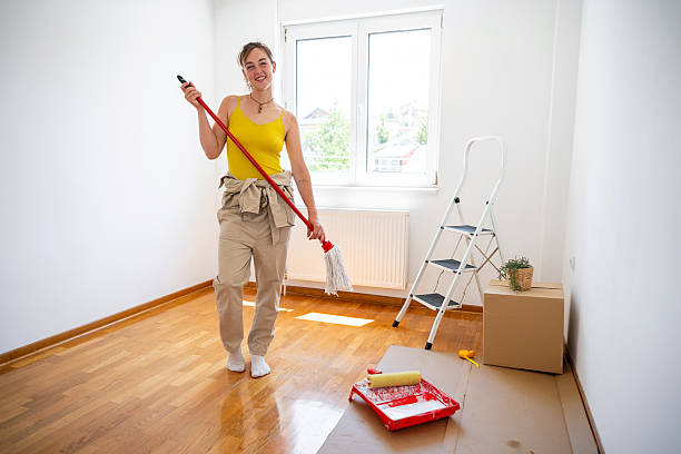 istock Woman smiling while holding a mop in a freshly cleaned room 2229909476