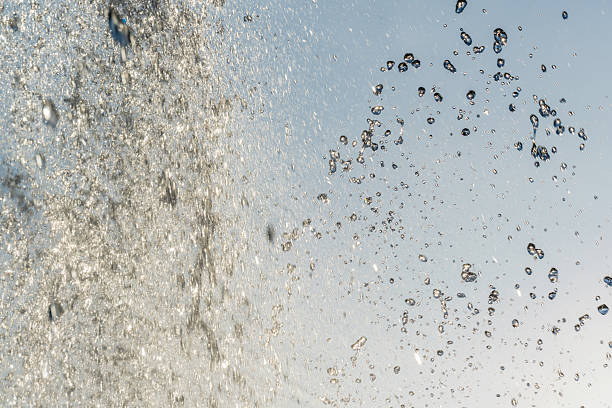 istock Splashes and jets of water against light background. 2229909710