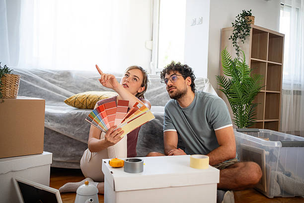 istock Young couple choosing paint colors while renovating their living space 2229911478