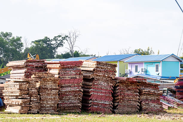 istock Stacked concrete formwork panels at construction site. Industrial building materials used for structural support and reuse, stored outdoors in preparation for construction or renovation work. 2229912736