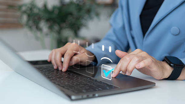 istock Businesswoman using a laptop to select customer feedback rating on a virtual screen, concept of online survey, satisfaction evaluation, and service review 2229914044