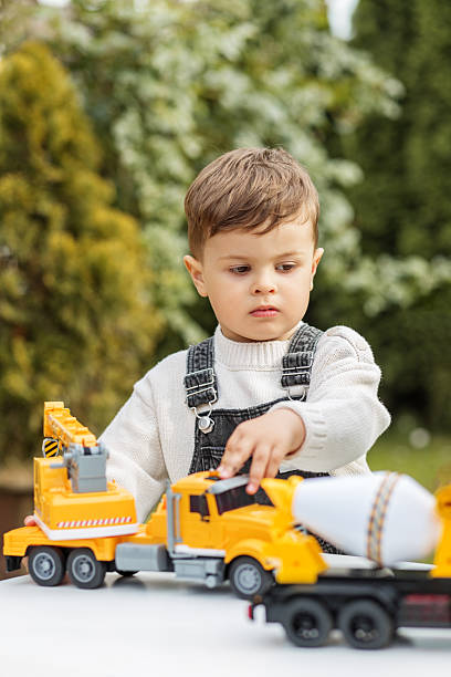 istock Little boy playing with toy construction truck 2229915056