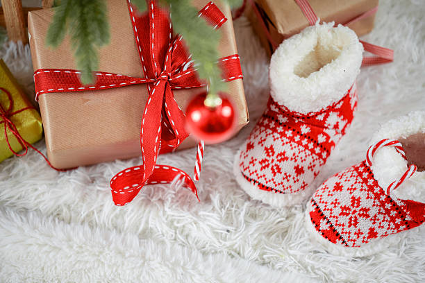 Christmas Gifts and Baby Booties Under Tree