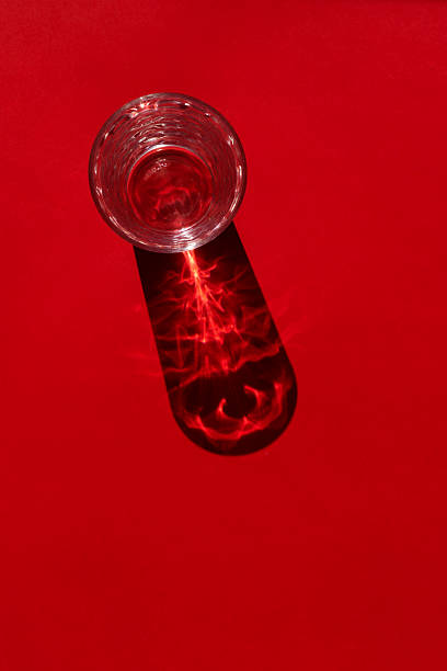 Glass of water on red background