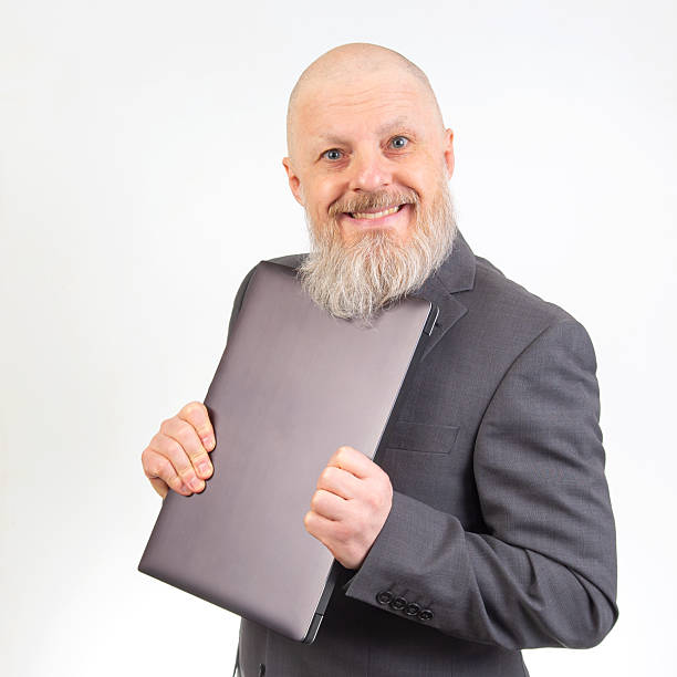 istock Smiling man in a suit holding a portfolio against a plain background during a business event 2229921334