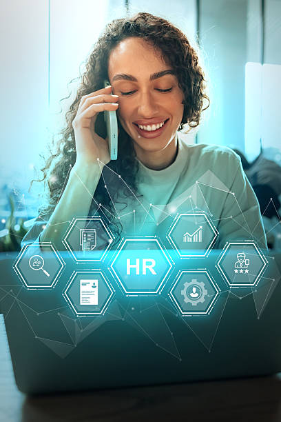 istock Employee engaged in HR tasks while on a phone call in a modern workspace during daytime 2229925153