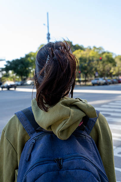 istock Student walking across the street looking away 2229928175