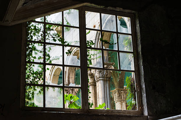 View of Stone Columns Through an Old Window. High quality photo