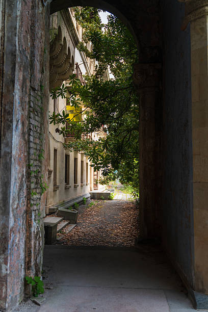 istock Abandoned Corridor with Arches and Stone Columns 2229933002