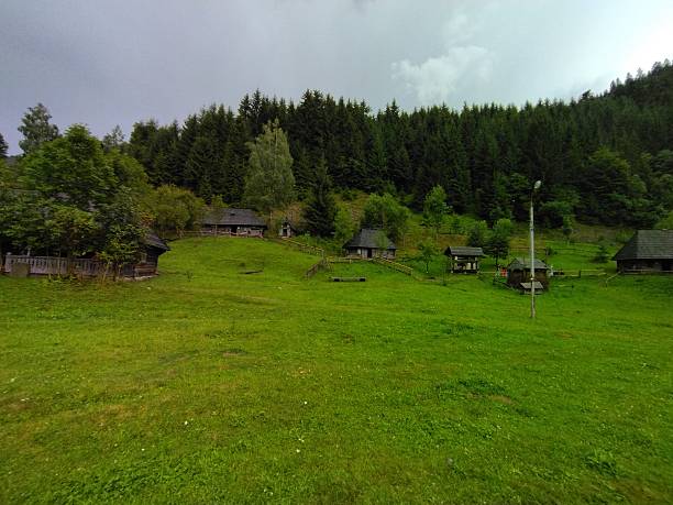 Ancient traditional ukrainian forest carpatian cottage in forest. Huts and villages in Carpatian mountains