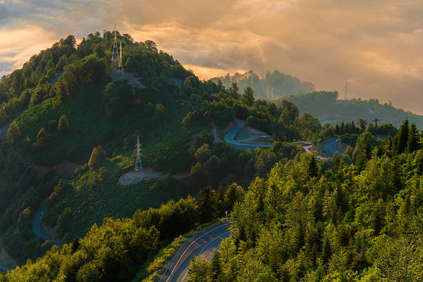 Winding Road Through Green Landscape with Utility Towers. High quality photo