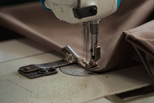istock A seamstress works on a production sewing machine at an enterprise, sewing bed linen 2229936921