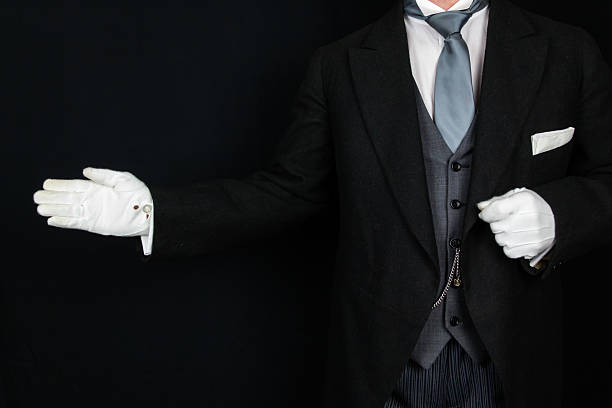 istock Butler in White Gloves With Welcoming Gesture 2229938955