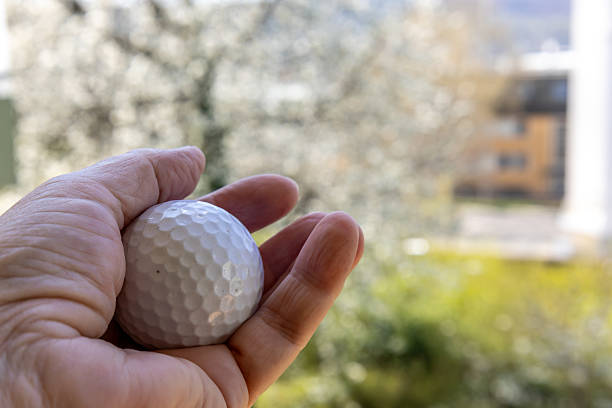 istock Hand holding a golf ball outdoors 2229940121