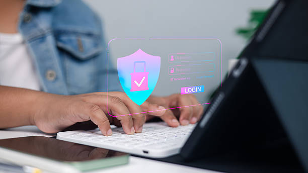 istock Online security, data protection, and safe access in a professional setting.Close-up of hands typing on keyboard with digital shield and padlock overlay. 2229940386