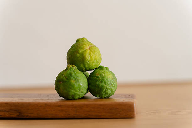 Kaffir limes. Citrus fruit preparation. Aromatic ingredient concept.