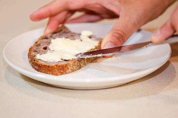 istock Spreading Butter on a Slice of Bread 2229942214