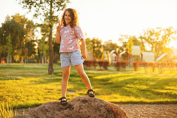 Kid girl in park at sunset