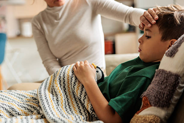 istock Mother Feeling Son’s Forehead for Fever 2229943912