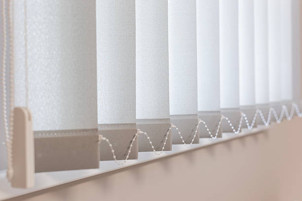 istock Light Gray Vertical Blinds for Window Privacy and Sun Protection 2229944854