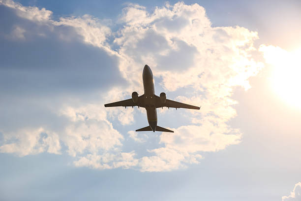 istock Airplane flying against a backdrop of clouds during sunset in the evening sky 2229945154
