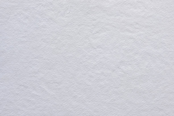Close-up of plain white paper surface with subtle natural fibers — ideal for background use in design projects, mockups, stationery, and minimal art compositions.