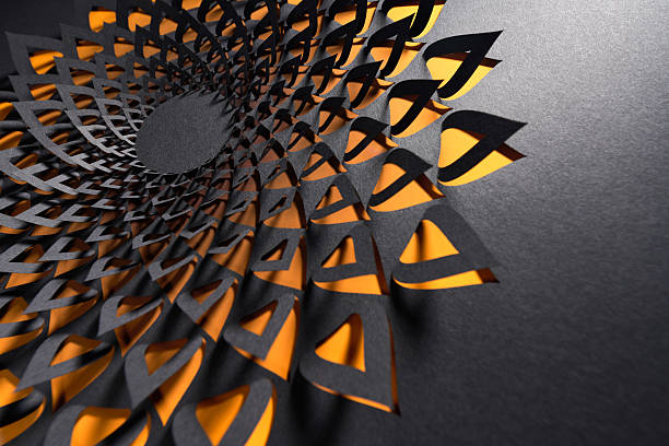 istock Bold black and orange geometric paper mandala with layered triangular cutout design 2229946099